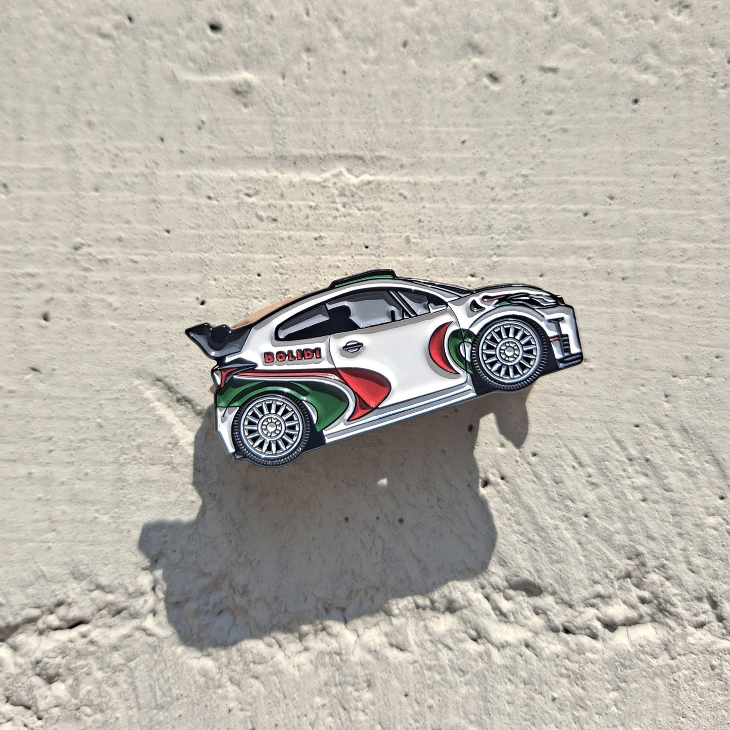 Toyota Yaris GR enamel pin on cement background