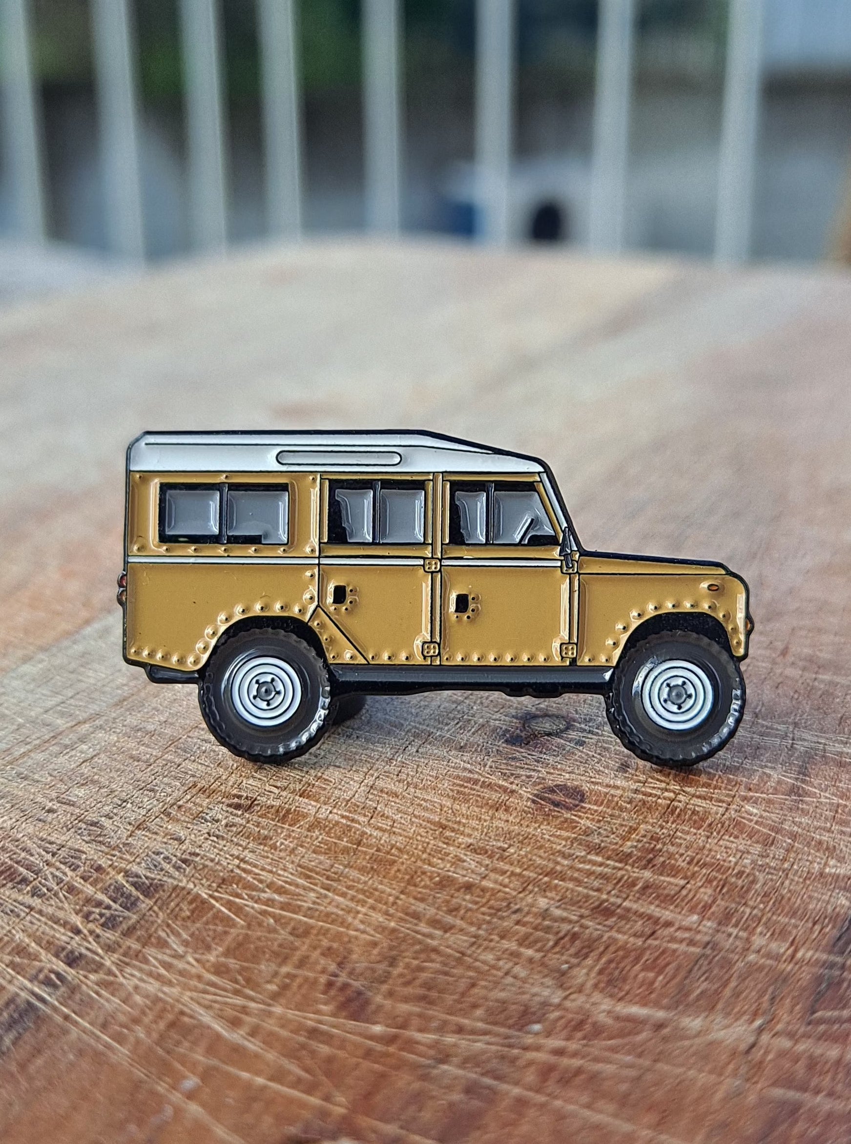 Defender Series III Sand Enamel Pin featuring the iconic Land Rover Defender design in sand color, with high-quality enamel finish and double black rubber pin clutches on the back