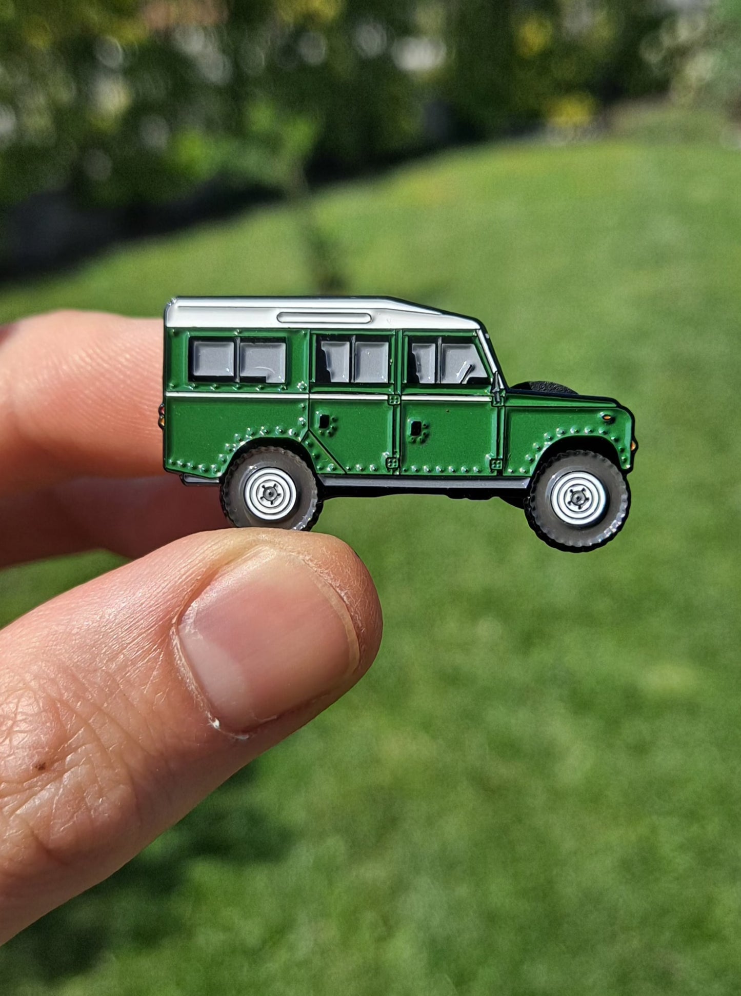 Defender Series III Sand Enamel Pin featuring the iconic Land Rover Defender design in green color, with high-quality enamel finish and double black rubber pin clutches on the back