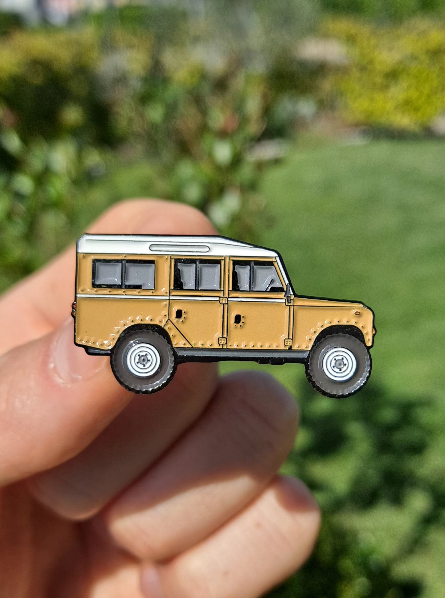 Defender Series III Sand Enamel Pin featuring the iconic Land Rover Defender design in sand color, with high-quality enamel finish and double black rubber pin clutches on the back