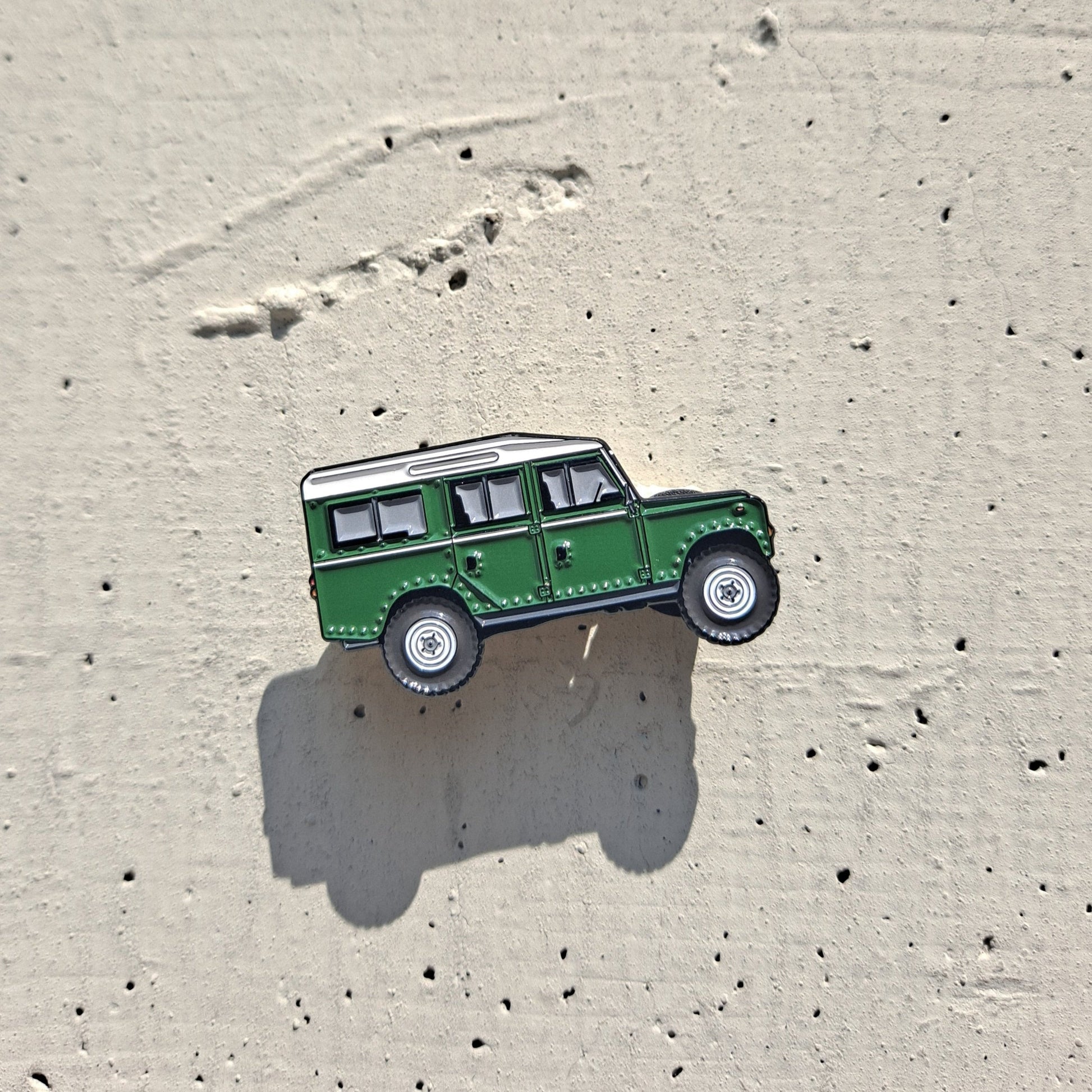 Defender Series III Sand Enamel Pin featuring the iconic Land Rover Defender design in green color, with high-quality enamel finish and double black rubber pin clutches on the back