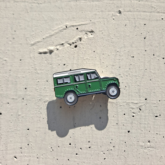 Land Rover Defender Series III green enamel pin on cement